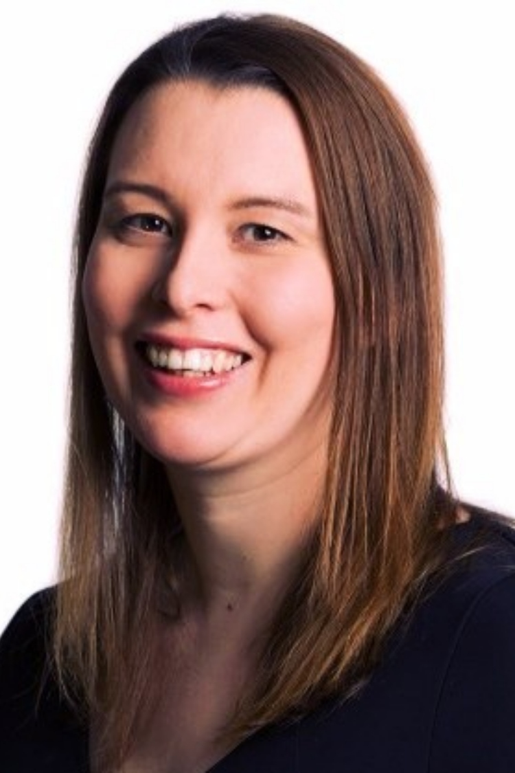 A headshot of Frances smiling at the camera. She is wearing a black shirt.