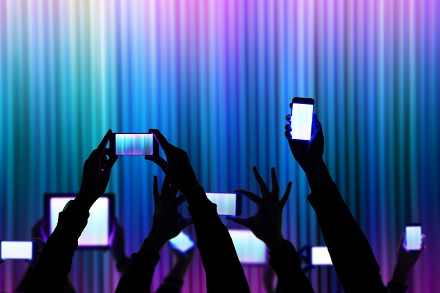 People raise his bright smartphone