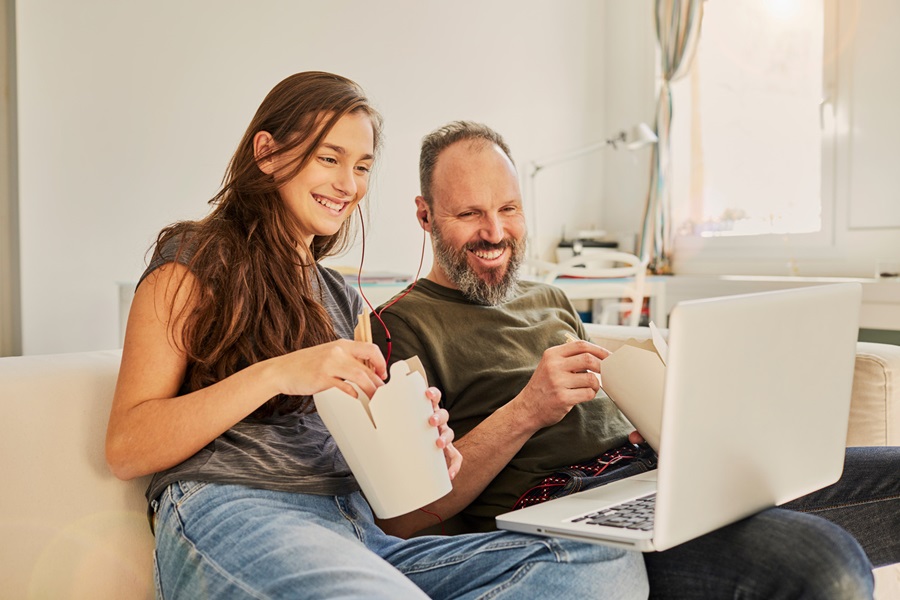 Father and daughter watching a movie together