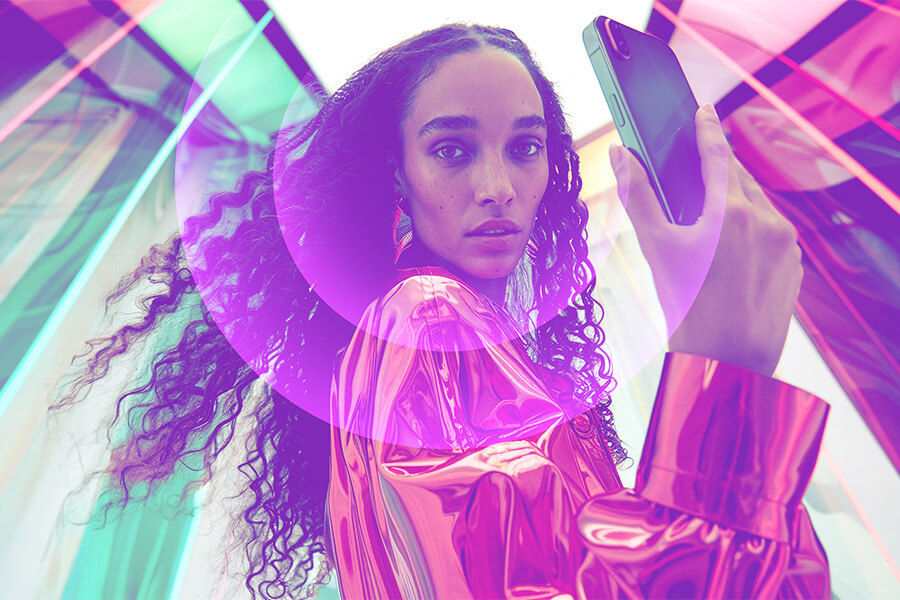 Stylish woman in futuristic setting using smartphone